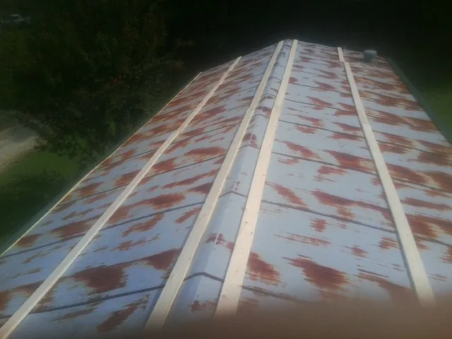 Rusted metal roof panels with new wood purlins before replacement — Storm Damage Roof Repair in Picture Rocks by Roofing Brothers